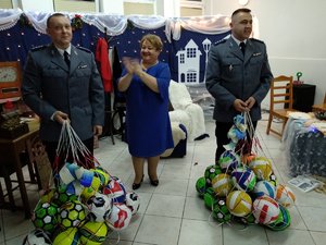 Dwaj policjanci z prezentami - piłkami dla podopiecznych Domu Dziecka we Fromborku