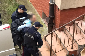 Zatrzymany mężczyzna prowadzony przez policjantów