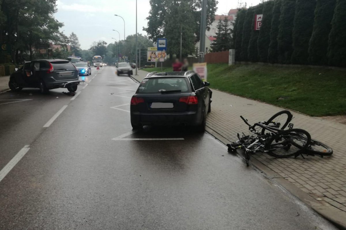 Miejsce zdarzenia drogowego w powiecie oleckim. Uszkodzone samochody i rowery na drodze