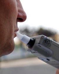 mężczyzna trzyma w ustach ustnik w celu zbadania stanu trzeźwości