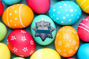 Kolorowe pisanki, a na środku pisanka z logotypem policji