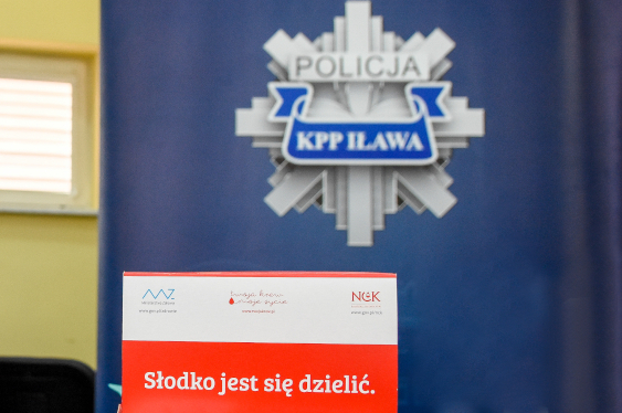 Pudełko czekolad dla uczestników akcji a w tle logotyp KPP w Iławie