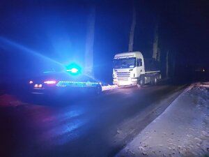 cysterna z mlekiem przed nią radiowóz na sygnałach świetlnych