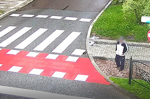 Zrzut ekranu z monitoringu, na którym widać poszukiwanego mężczyznę obok przejścia dla pieszych