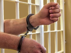 ręce wystające z za krat