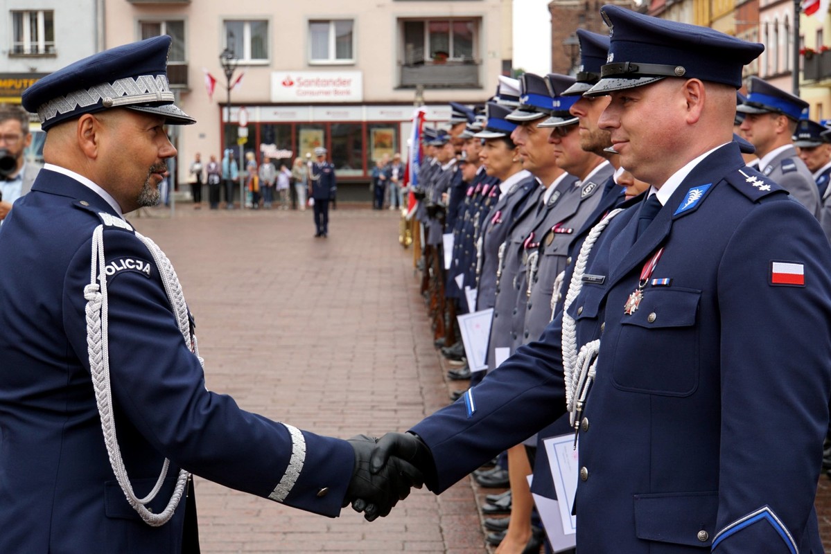 Wręczenie przez generała awansu policjantowi stojącemu w szeregu