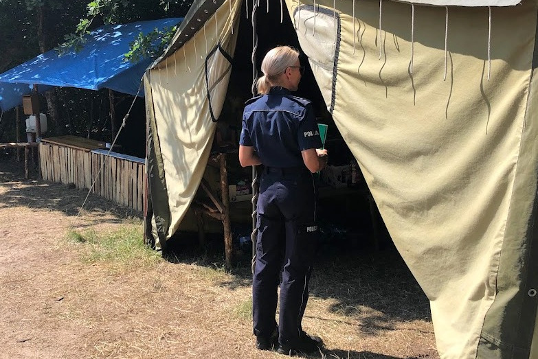 Policjantka podczas kontroli przy namiocie harcerzy