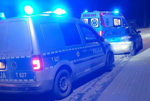 Auto, radiowóz i karetka pogotowia na drodze.