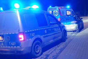 Auto, radiowóz i karetka pogotowia na drodze.