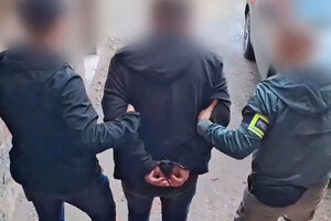 Zatrzymany mężczyzna prowadzony przez policjantów