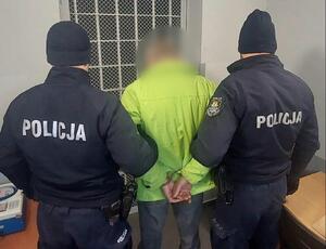 policjanci prowadzą zatrzymanego