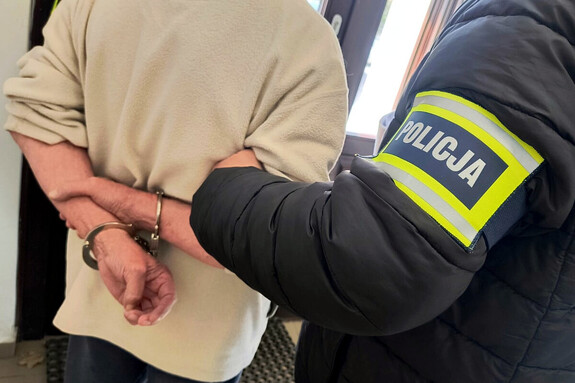 Zatrzymany mężczyzna prowadzony przez policjantów