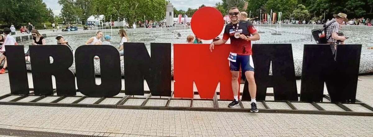 Zawodnik a w tle napis IRONMAN